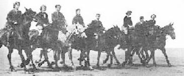 Riding horses on the beach c1920